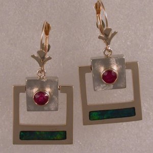 JE35- Earrings shown in white and yellow gold with rubies and opal.