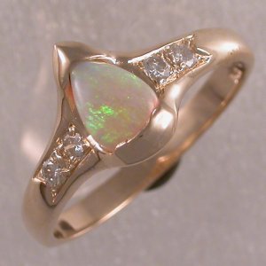 Custom made 14KT yellow ring with pear shaped opal and diamonds.