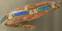 JM50-14KTY gold bracelet with solid stone opal inlay and diamonds.